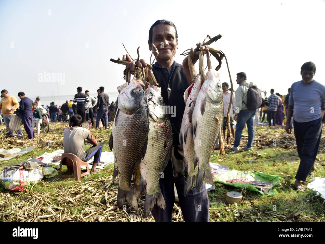 January 7, 2024, Guwahati, Guwahati, India: A man buys fishes at Deeporbeel during annual fishing ahead of the Magh Bihu celebration at outskirt of Guwahati city India on Sunday 7th January 2024. (Credit Image: © Dasarath Deka/ZUMA Press Wire) EDITORIAL USAGE ONLY! Not for Commercial USAGE! Stock Photo