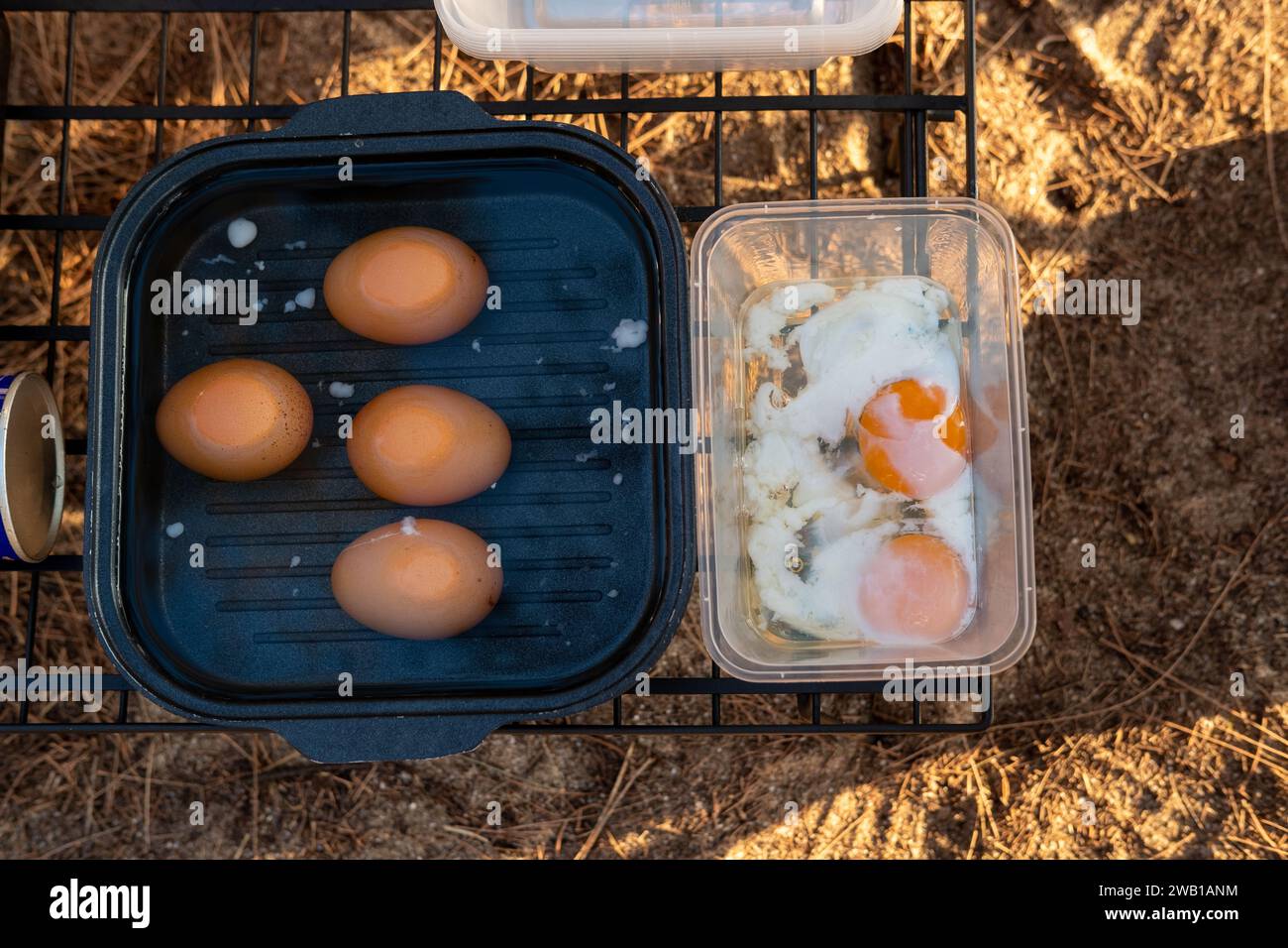 Breakfast poached eggs in a pan While going camping to relax Stock
