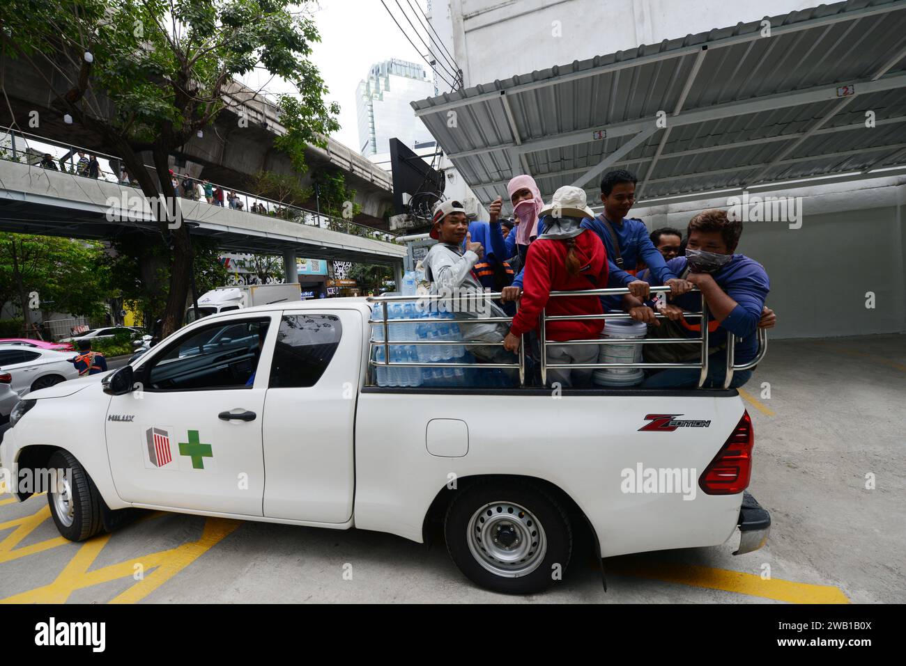 A Pickup truck fully loaded with people riding in the rear in Bangkok, Thailand. Stock Photo