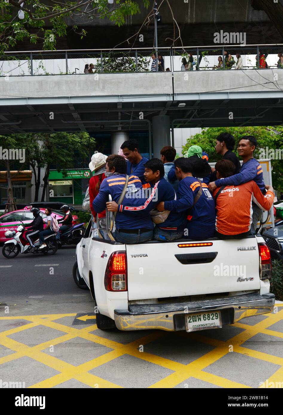 A Pickup truck fully loaded with people riding in the rear in Bangkok, Thailand. Stock Photo