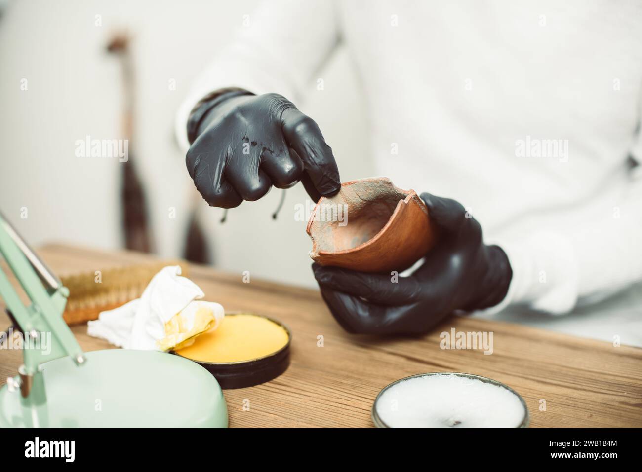 The man cleaning mould on leather product. Leather care concept. Stock Photo