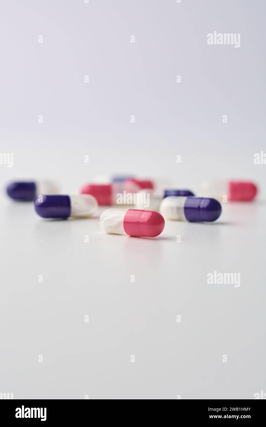 close-up of blue and pink dry powder inhalation capsules, contain dry powder form of the medication released and inhaled into the lungs isolated Stock Photo