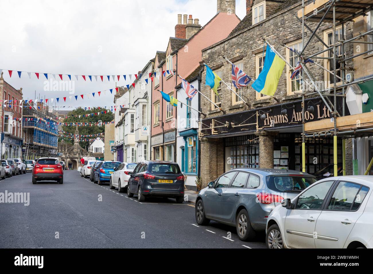 Malmesbury town centre, view along high street in this Wiltshire town, Ukraine flags flying alongside Union Jack flags,England,UK Stock Photo