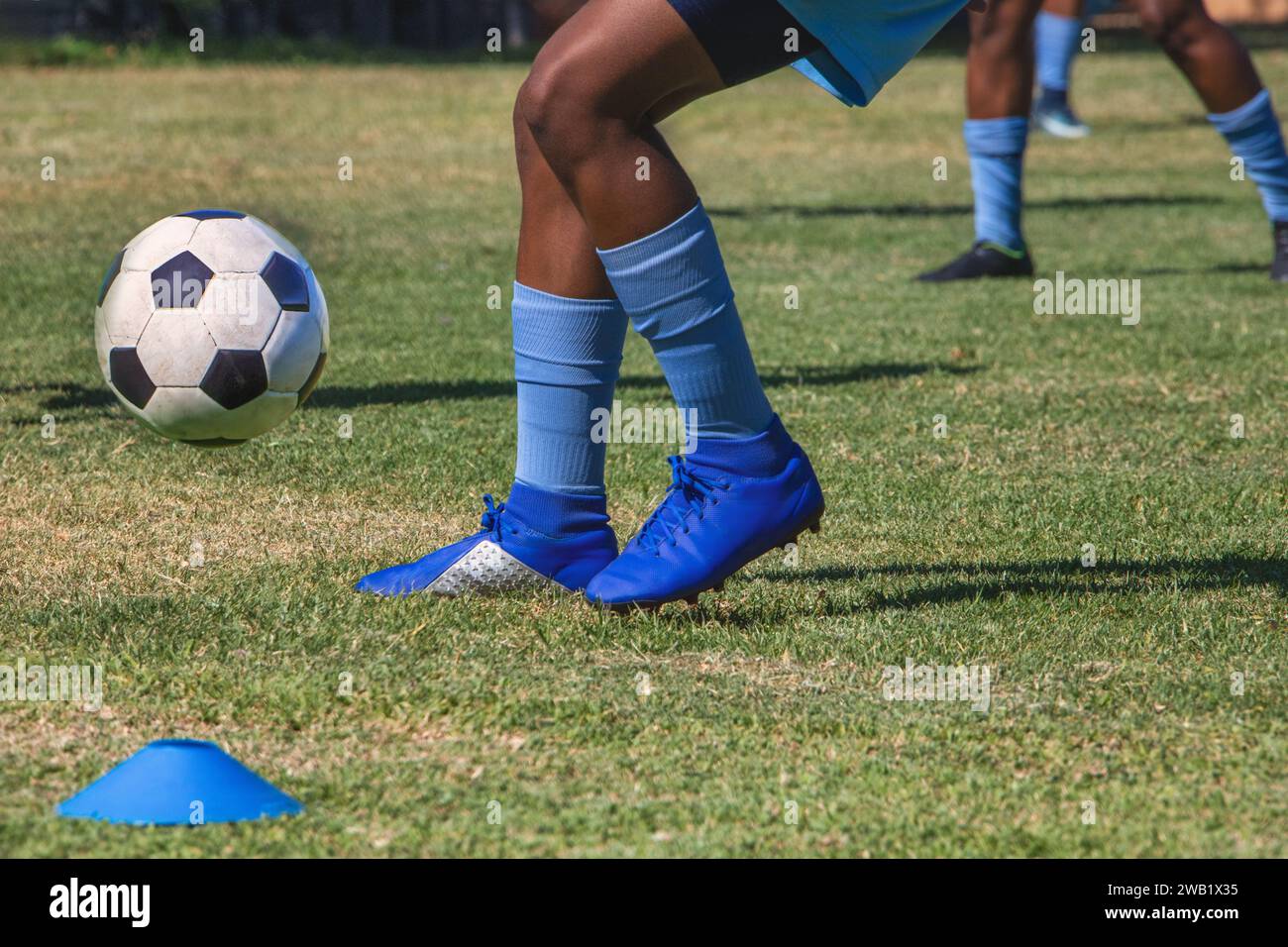 soccer college african american players in uniform kicking the ball on ...
