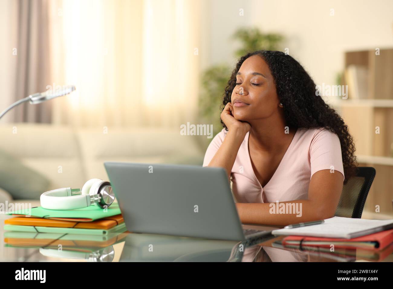Black student relaxing at home relieving stress Stock Photo