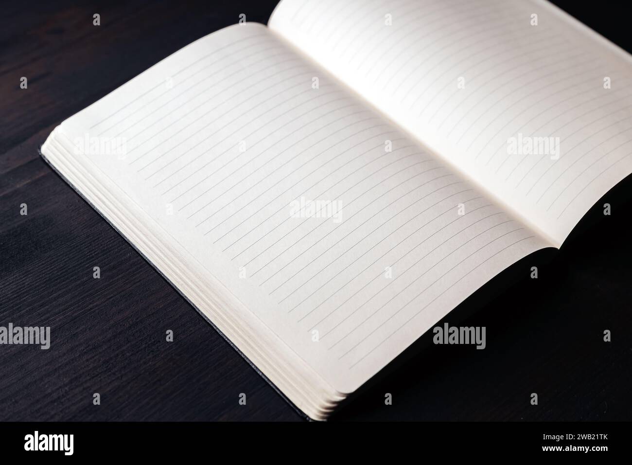 Open notebook on office desk with pencil, mockup copy space on blank pages Stock Photo