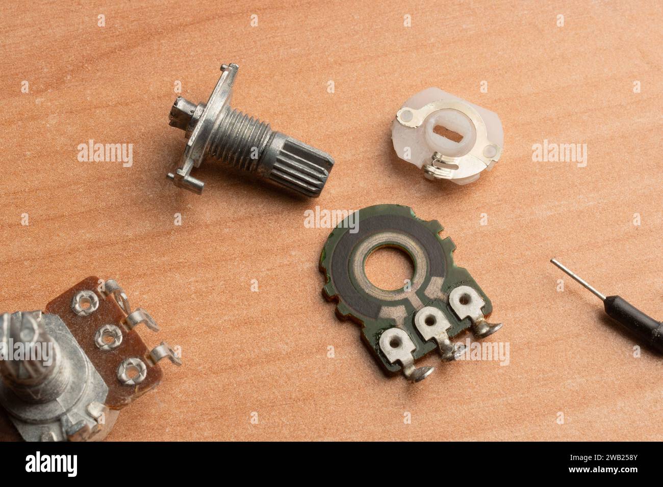 An electronic potentiometer disassembled into its functional parts