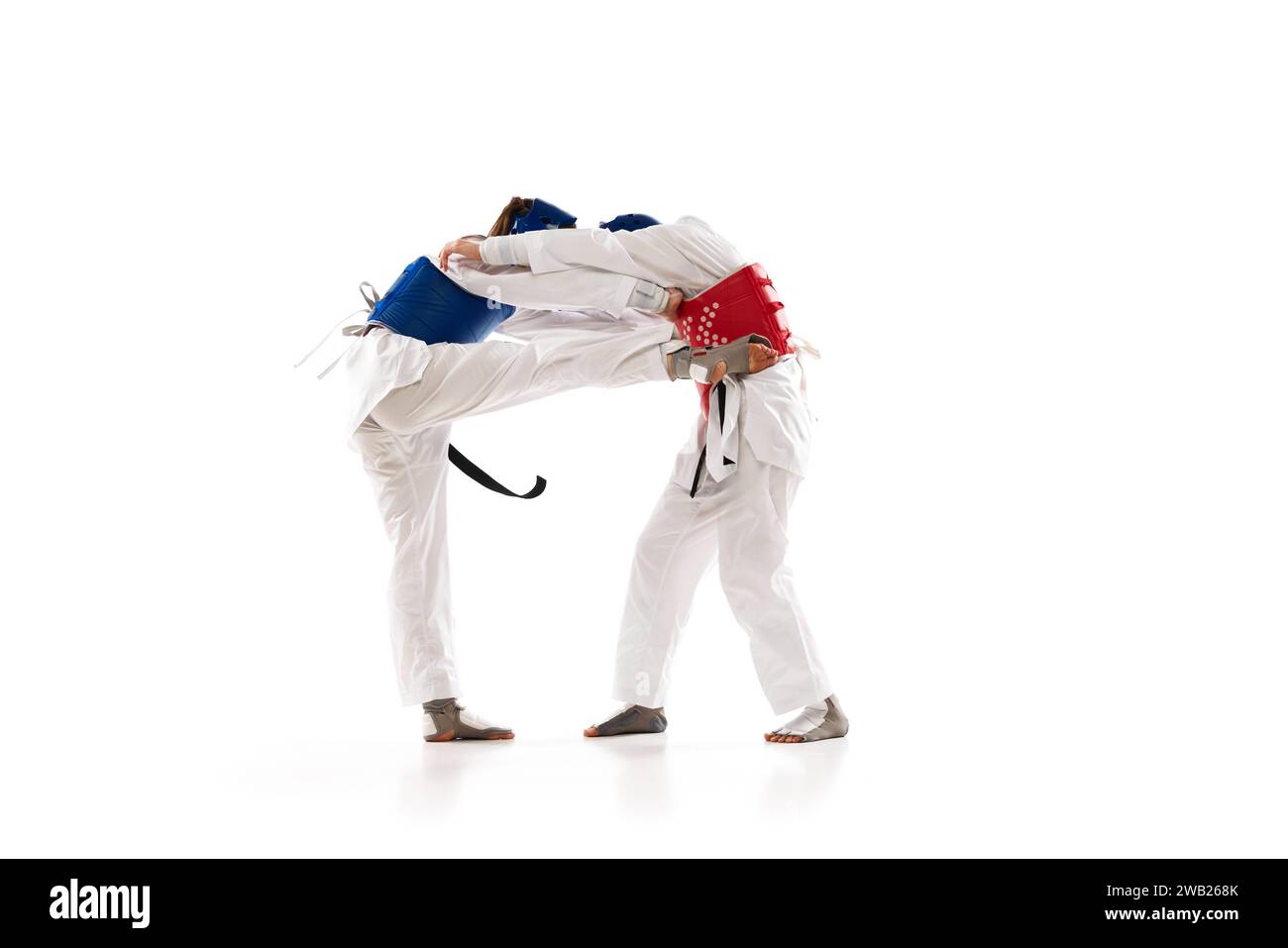 Sparring. Controlling combat action,. Two girls practicing taekwondo ...