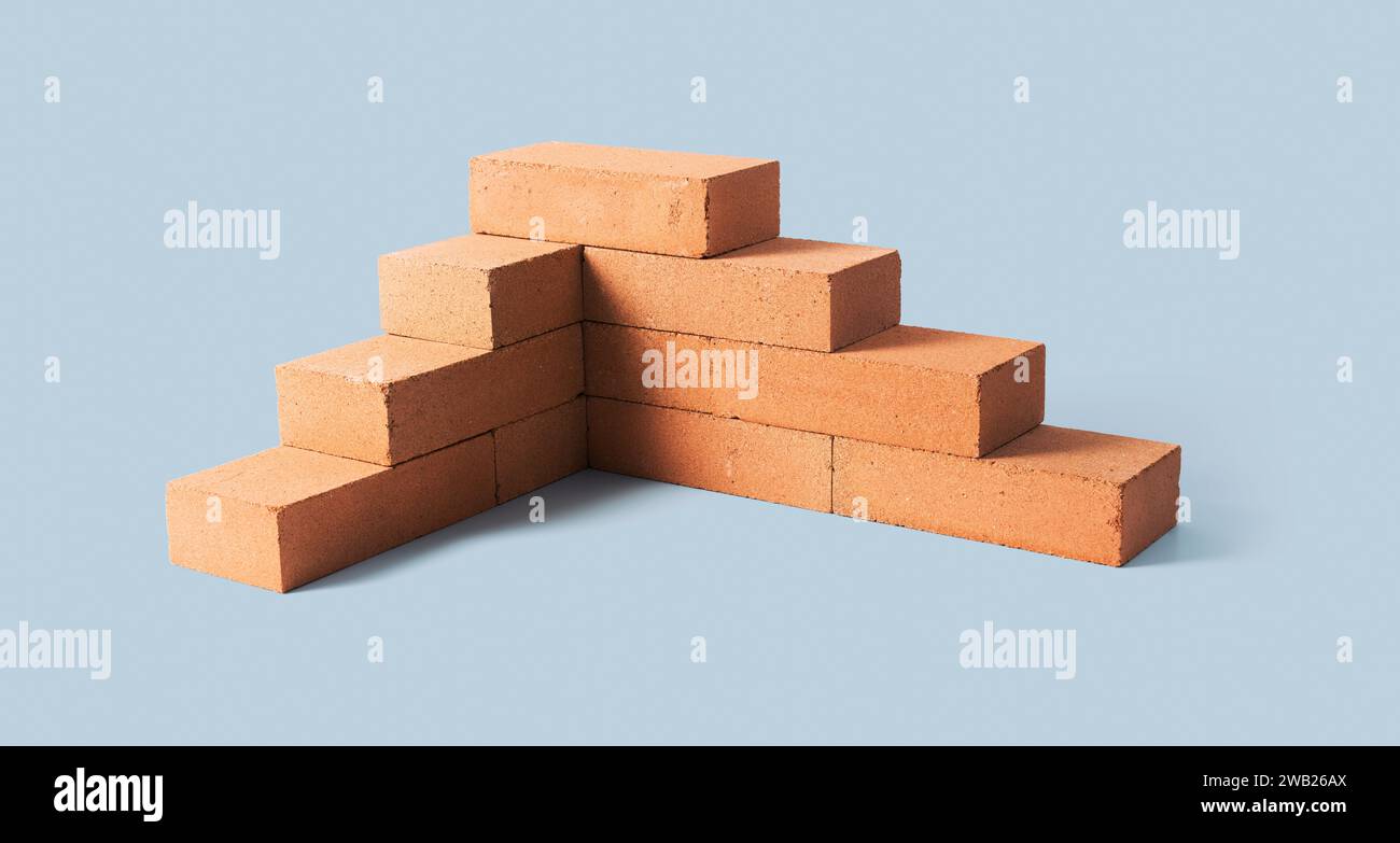 Brick wall under construction: building and home construction concept ...