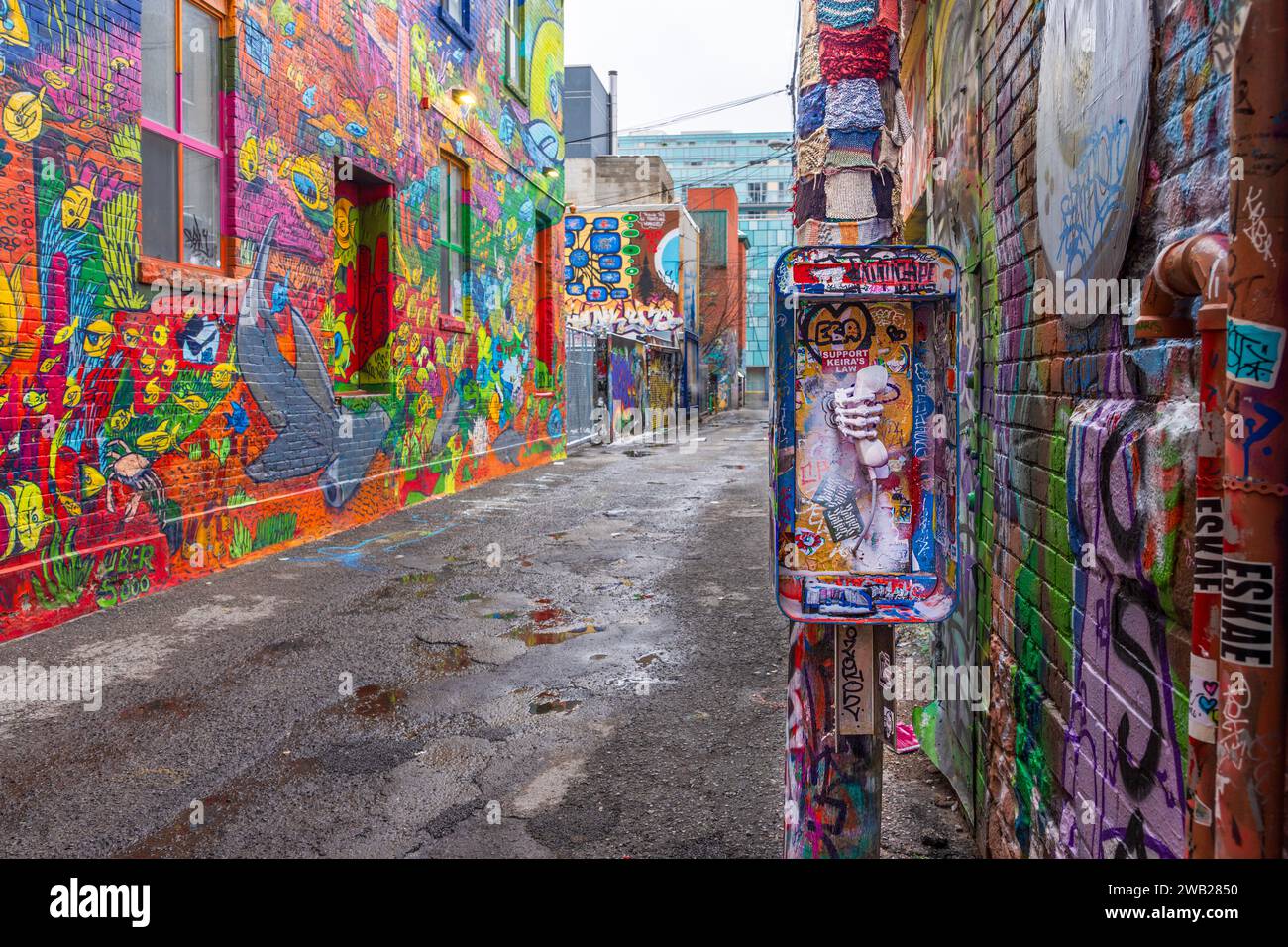 Graffiti Alley, also known as Rush Lane, is a hidden gem in Toronto's Fashion District. It is a narrow alleyway lined with colorful murals and street Stock Photo