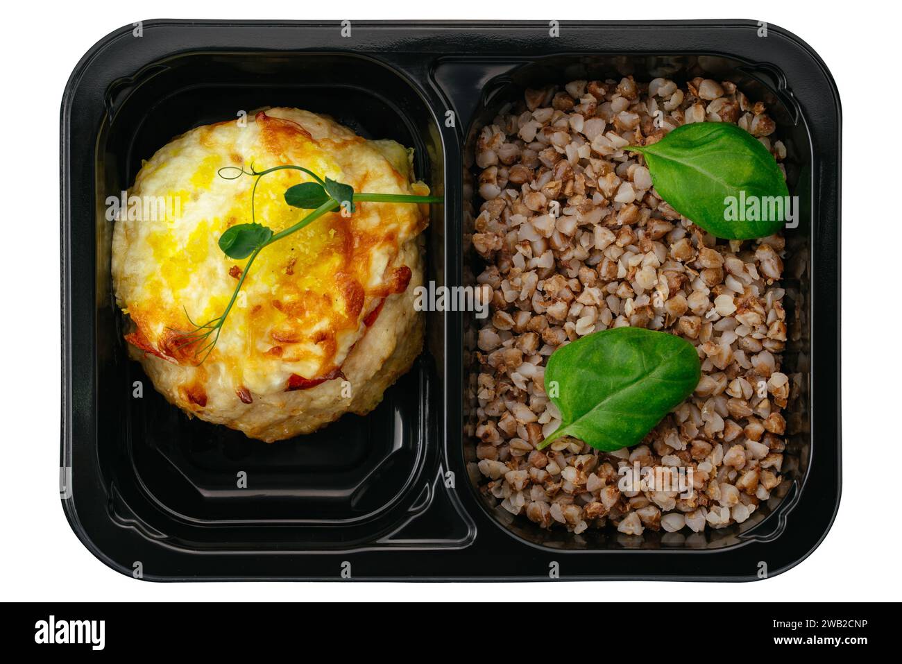 buckwheat with baked fish in lunch box on white background Stock Photo