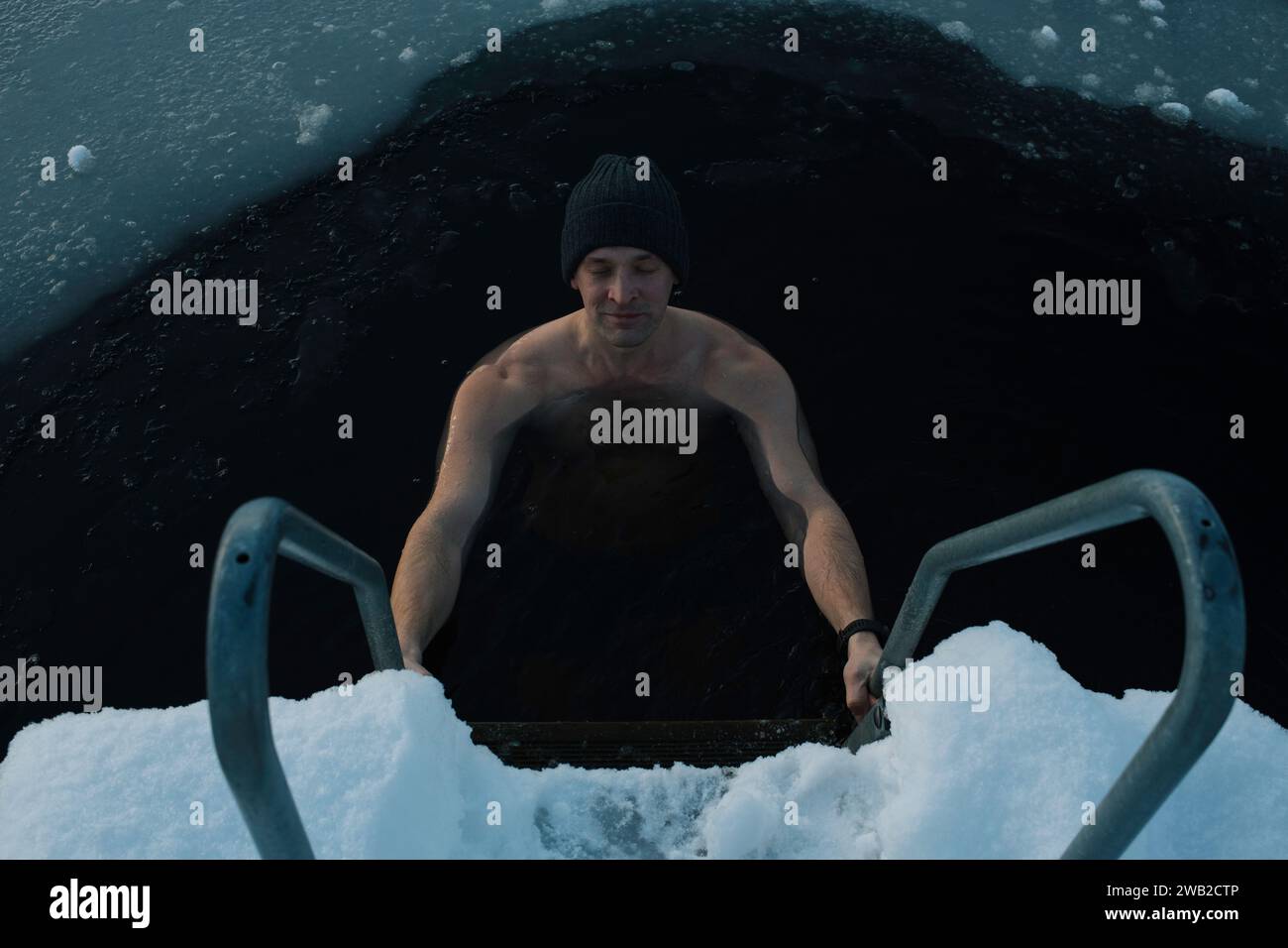 man breathing whilst taking a frozen water plunge in the Baltic sea Stock Photo