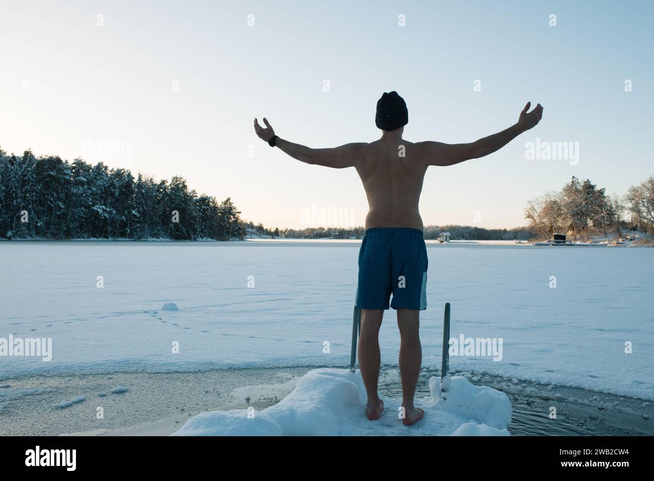 man getting ready for a frozen water plunge in the Baltic sea Stock Photo