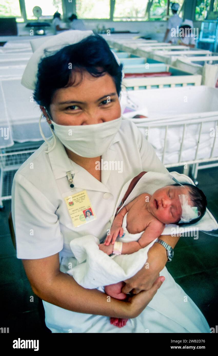 Nurse holding babies hi-res stock photography and images - Alamy