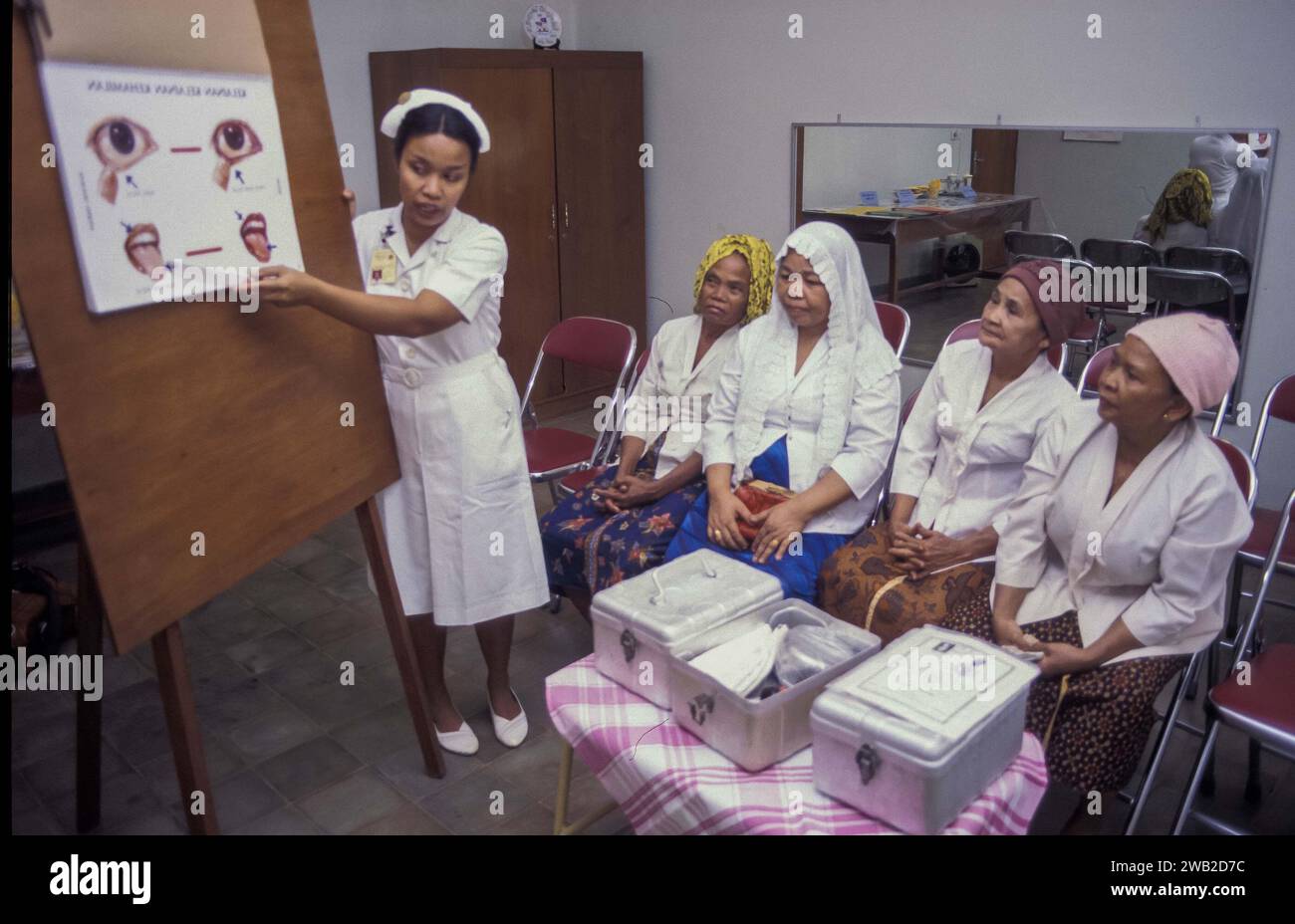 Indonesia, Jakarta - Nurse is giving healthcare instructions to midwifes Stock Photo
