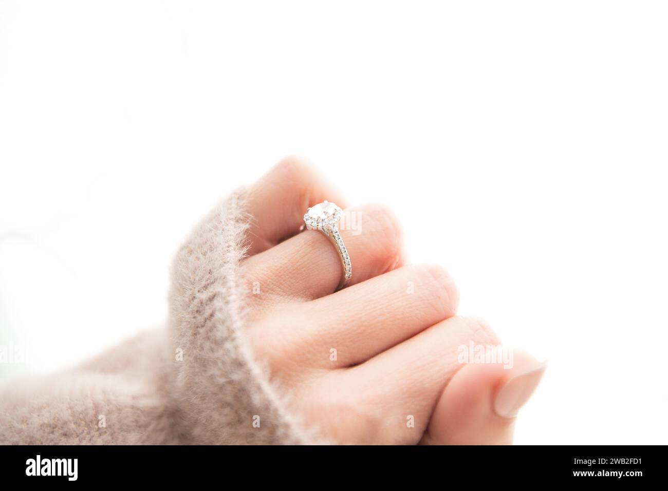 Halo Diamond Ring on Woman's Closed Hand Stock Photo