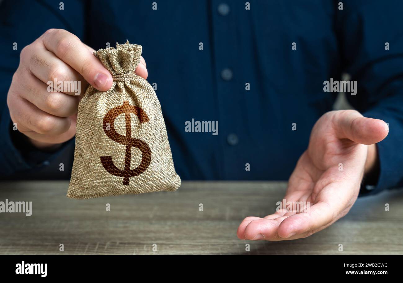 The man offers a deal in return. Giving gesture and dollar money bag. Banking and crediting. Mortgage, loan approval. Salary benefits. Attracting inve Stock Photo