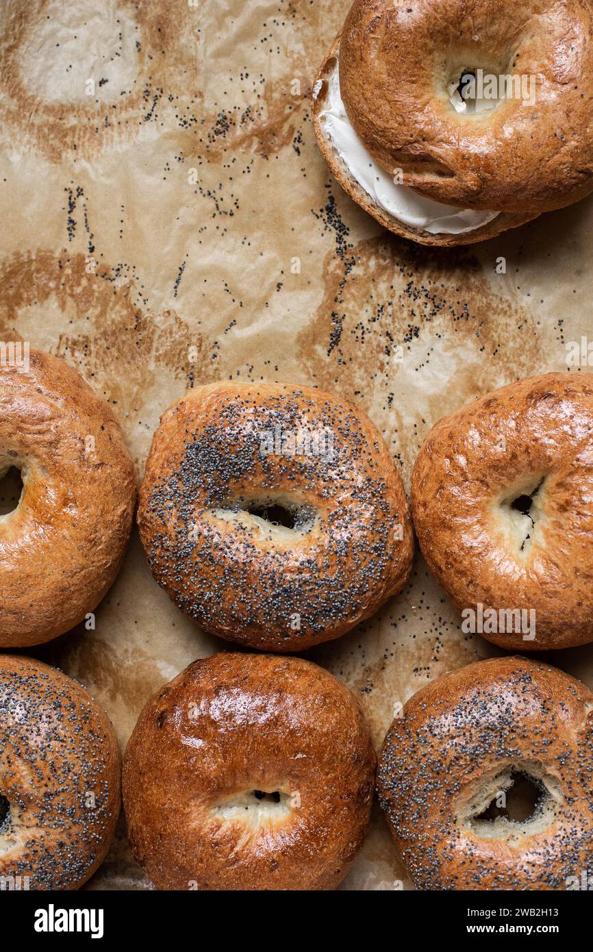 Poppy seed bagels with cream cheese on parchment paper Stock Photo