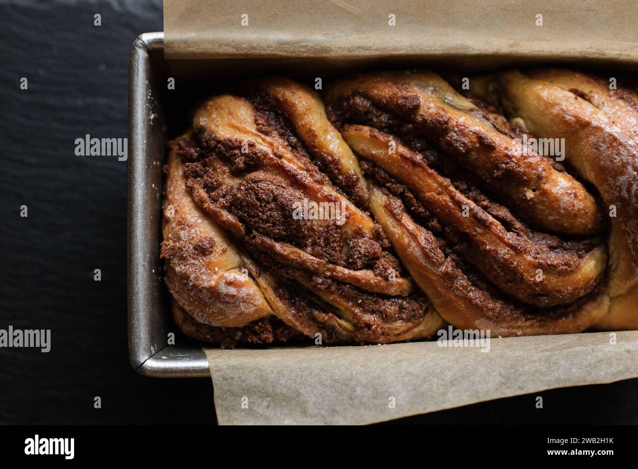 Chocolate babka in loaf pan with parchment paper Stock Photo