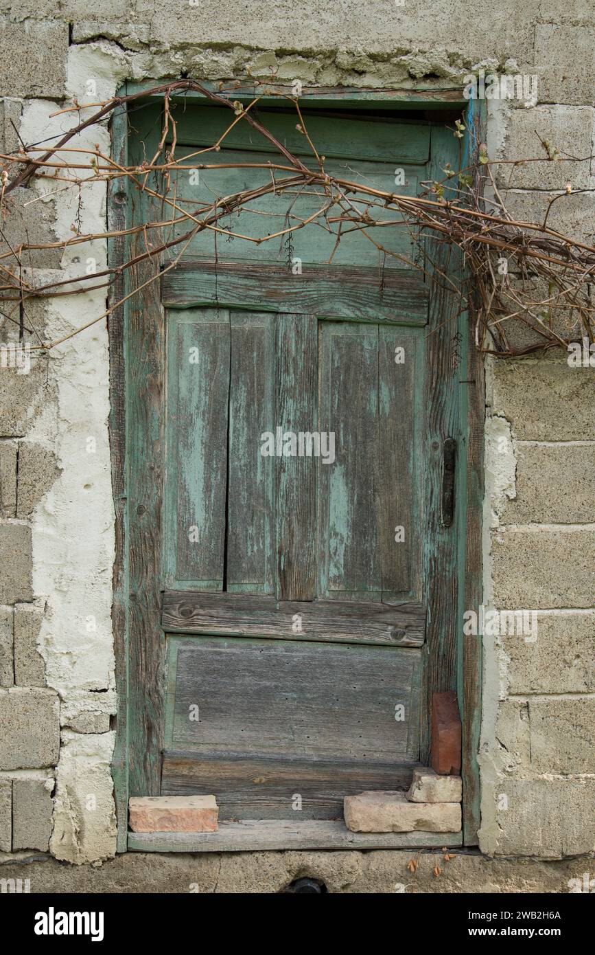 Sunja, Croatia, 05,04,2021: Old wooden rustic door on rural home wall. Stock Photo