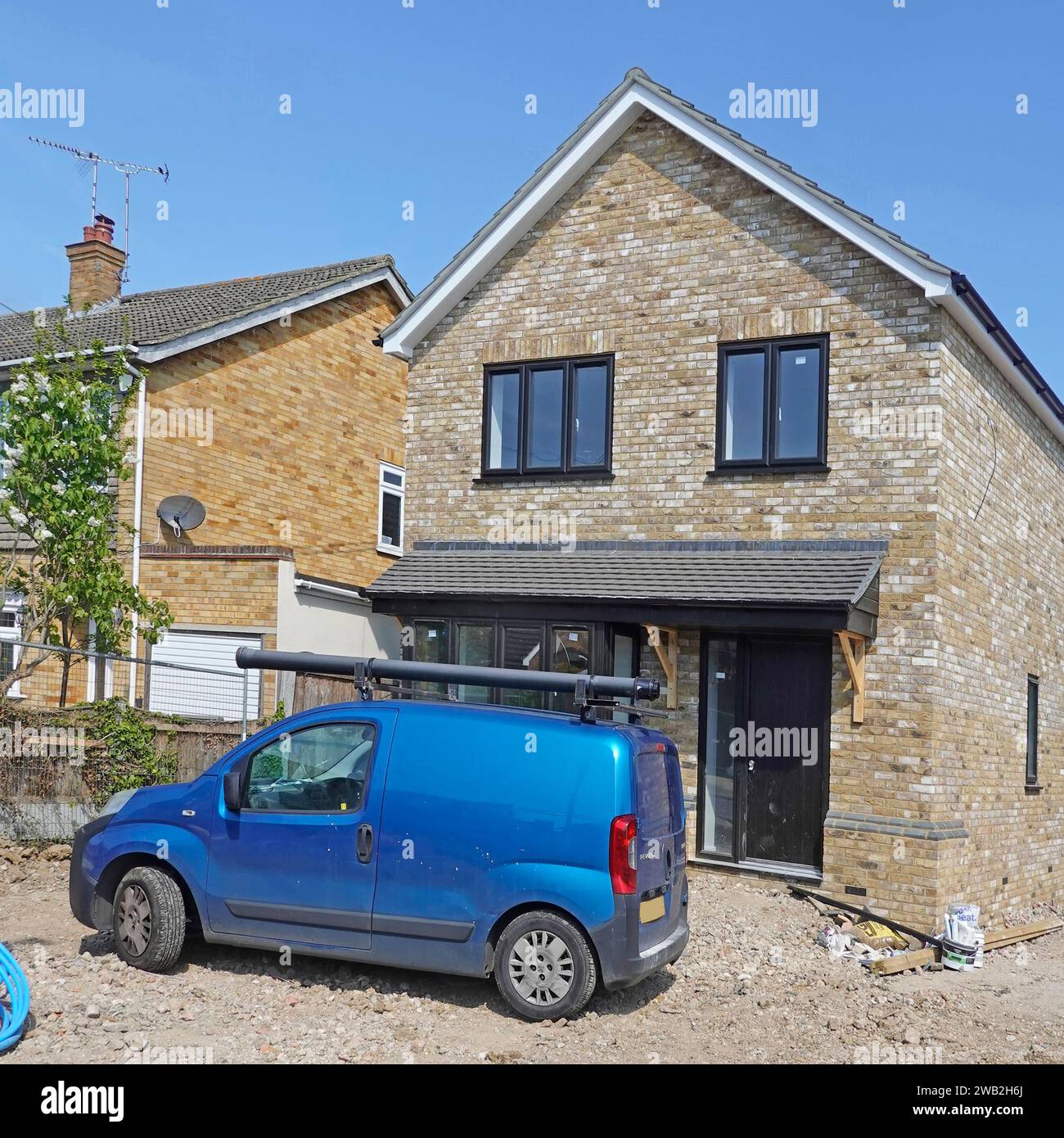 Alamy series 41 stages of work in progress pics detached house on infill plot from start to near complete blue van plumbers working indoors England UK Stock Photo