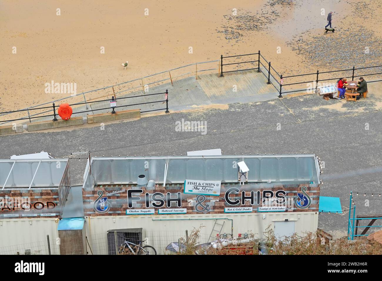Aerial roof top view Fish & Chips bar on seaside beachfront promenade few people about for retail seafront business out of season in Cromer Norfolk UK Stock Photo
