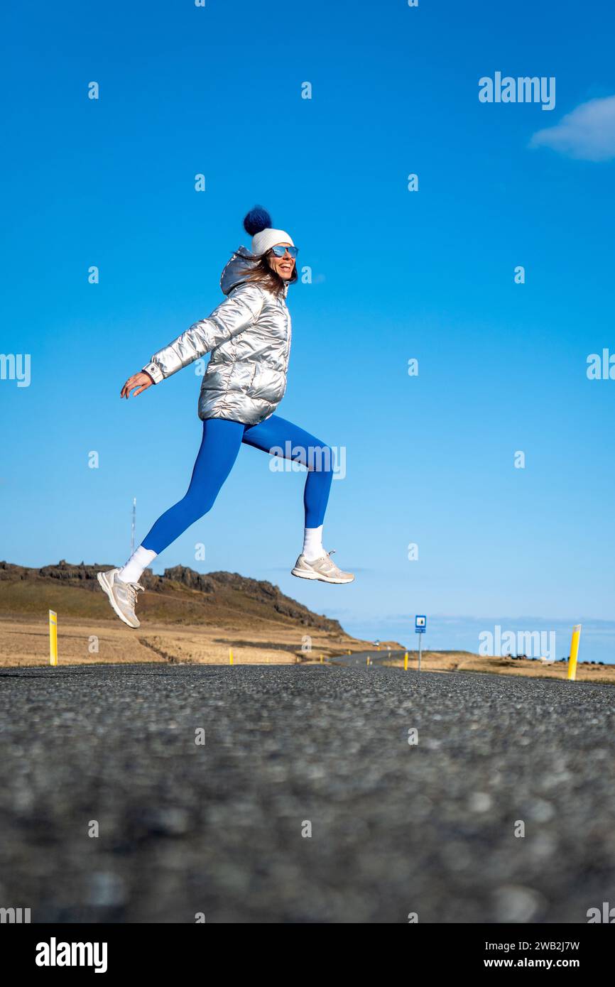 A young Caucasian woman posing on the beach against the sea Stock Photo ...