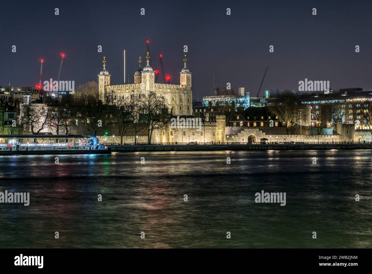 The White Tower of the Tower of London seen across the River Thames at night. Stock Photo