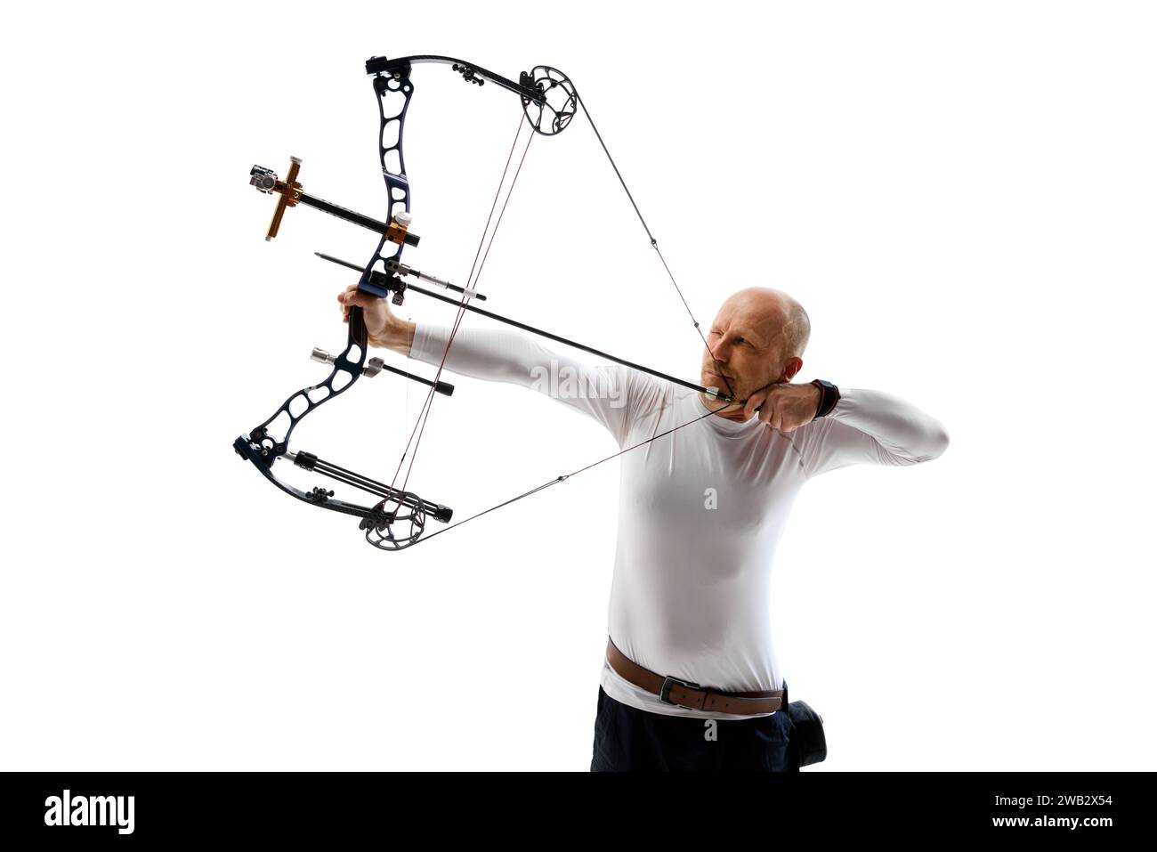 Man in his 40s, archery athlete with bow and arrow aiming at archery ...