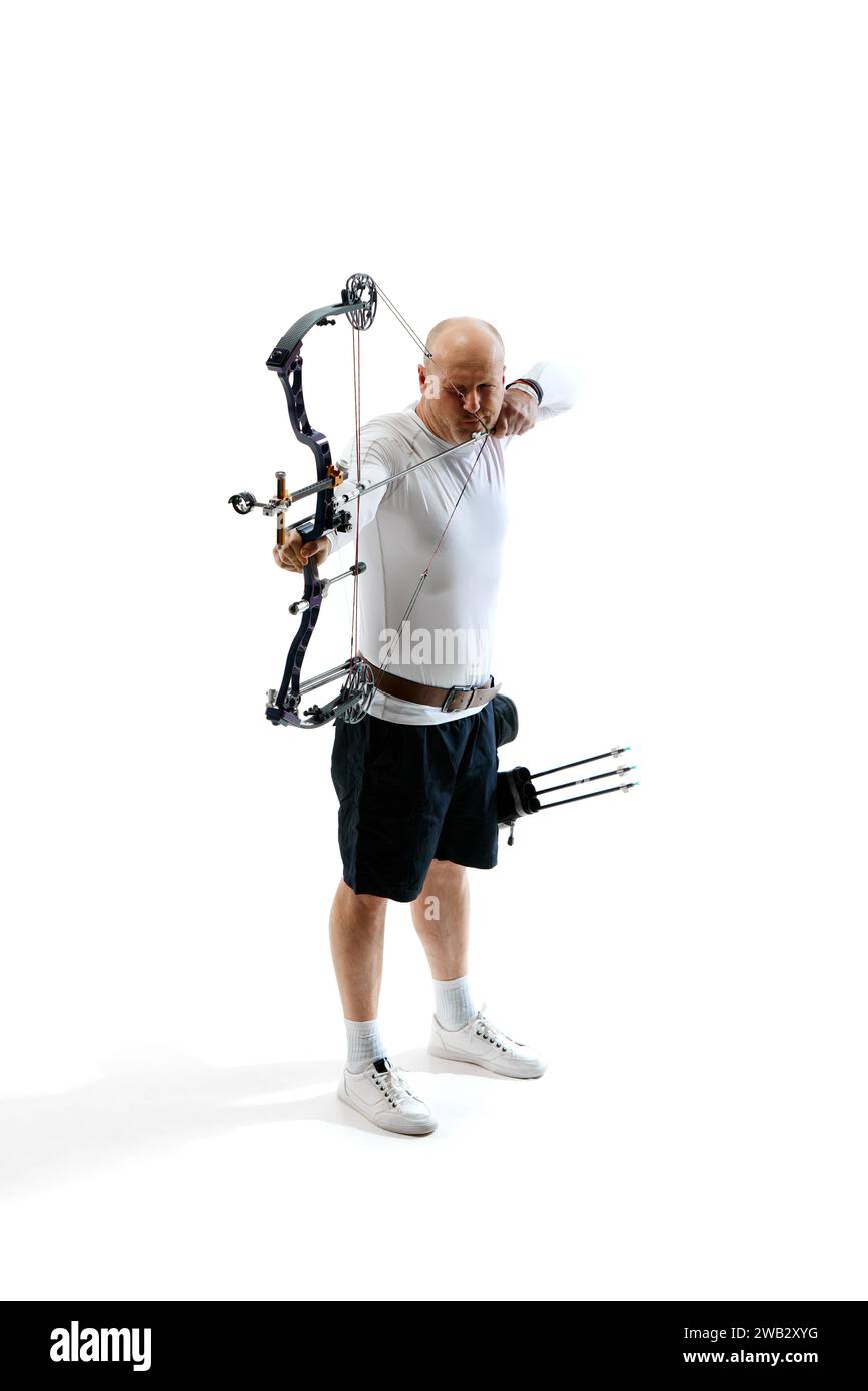 Man, professional archer training, aiming archery bow into target