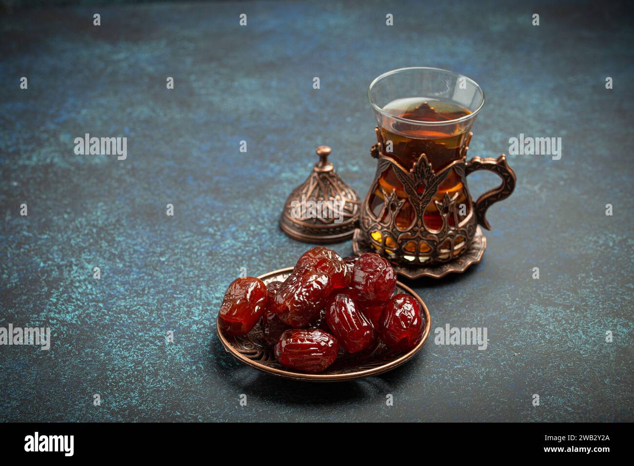 Breaking fasting with dried dates during Ramadan Kareem, Iftar meal