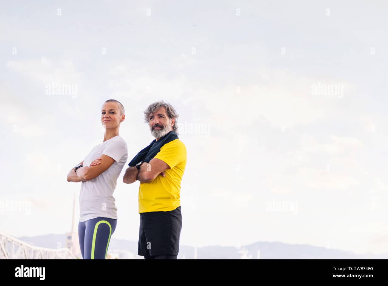 sportsman and woman posing with arms crossed Stock Photo - Alamy