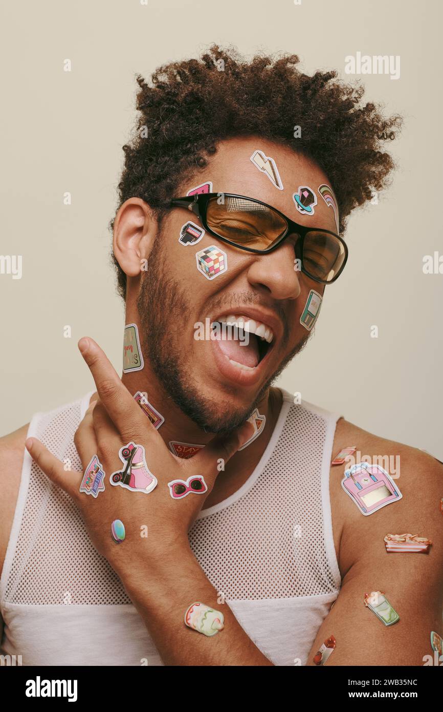 expressive african american fella in sunglasses with trendy stickers on ...