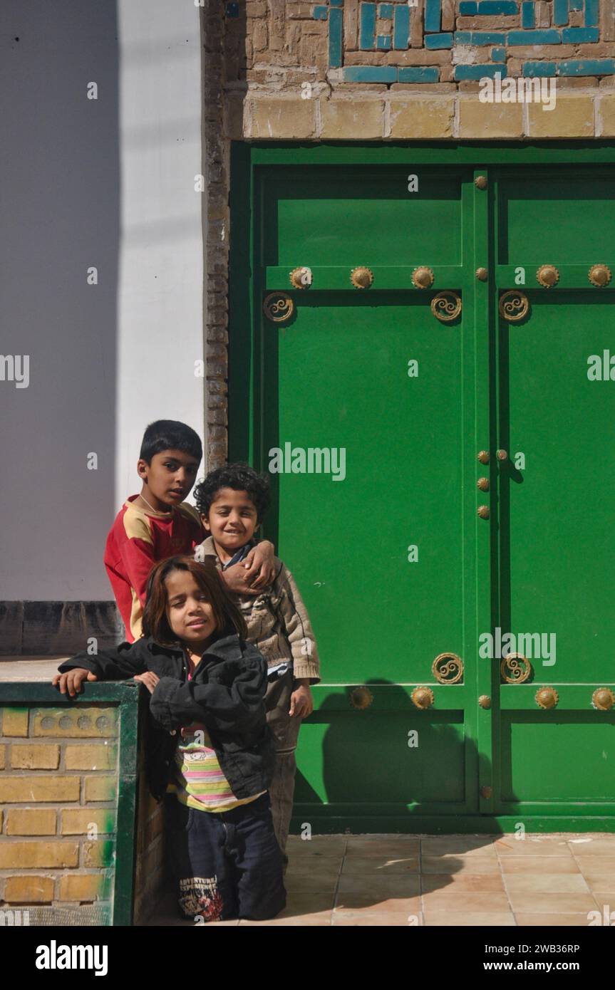 Cute and friendly local chirldren offered to pose for a photo in Yazd, Iran. Stock Photo