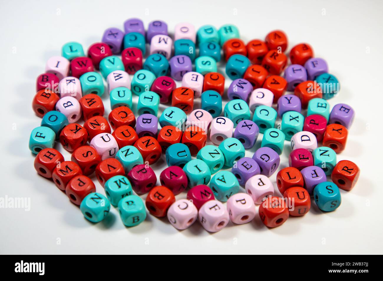 An array of colorful cubic beads with letters on a white background Stock Photo