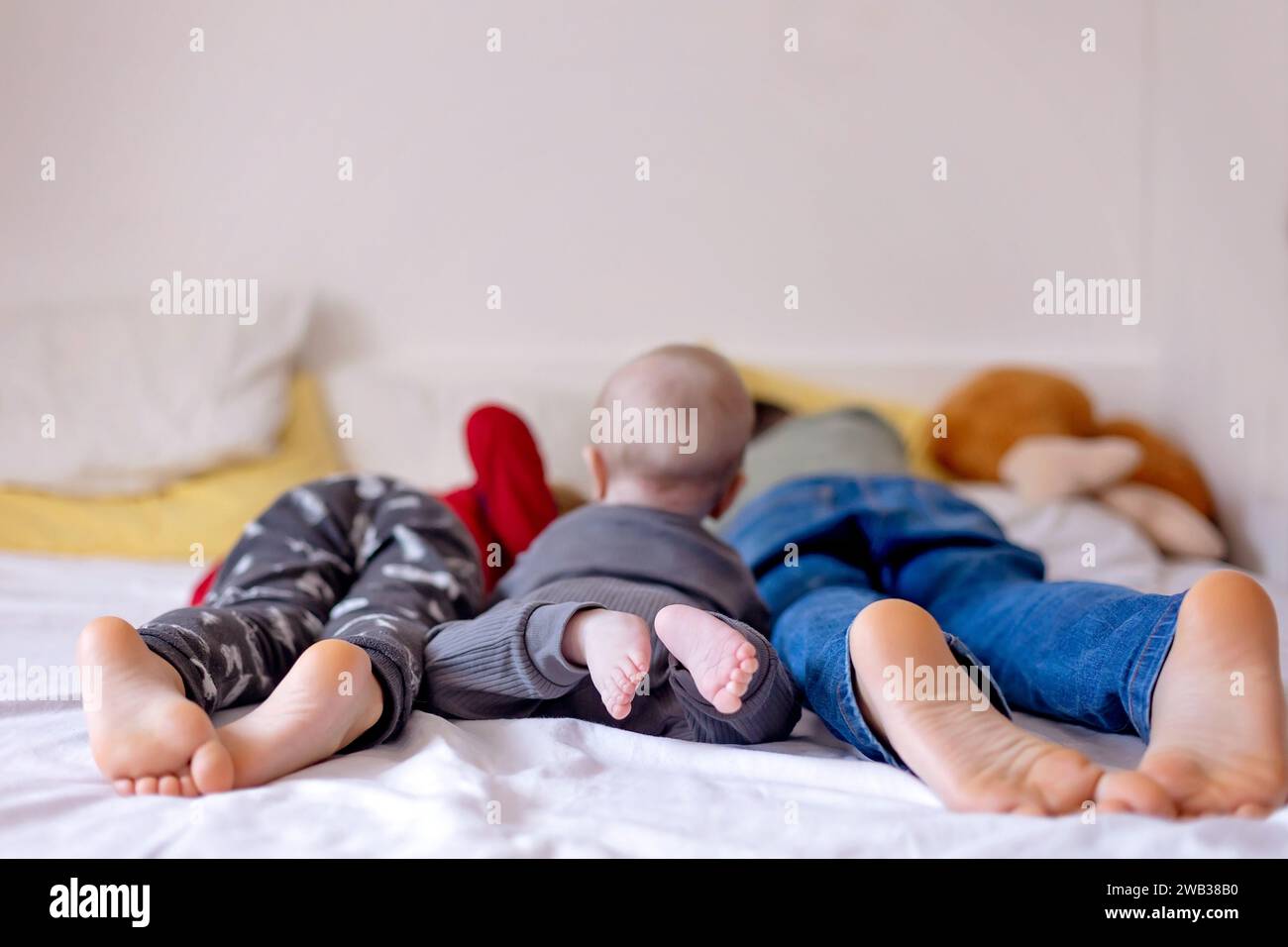 Chlildren feet, little baby boy and older brothers feet, baby lie down