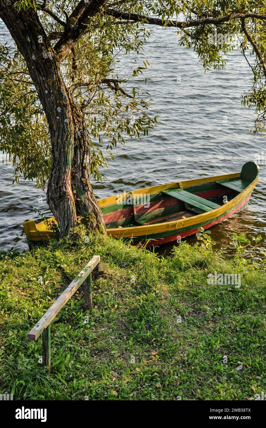 Boat painted the national colours of Lithuania on Lake Galve in Trakai, Lithuania Stock Photo