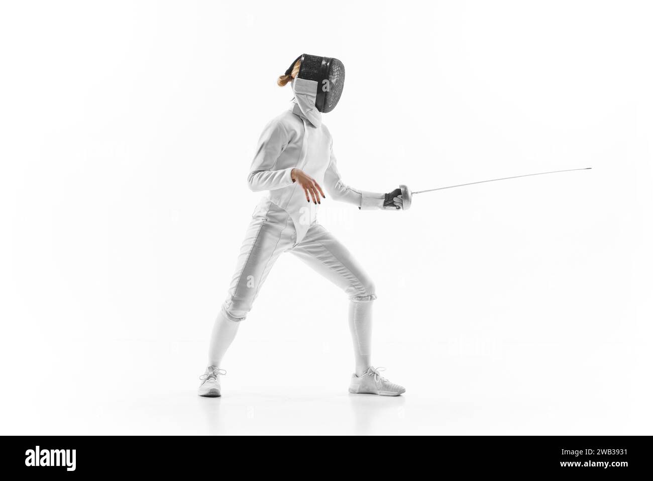 Female athlete in fencing gear showcasing her impeccable form, sword