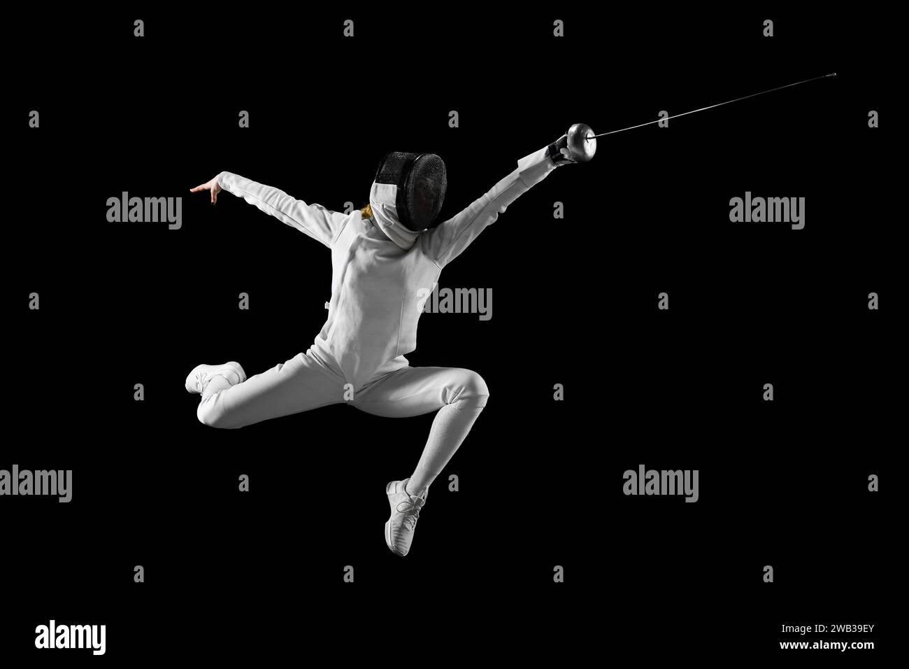 Artistry of combat. Female fencer gracefully executes complex fencing
