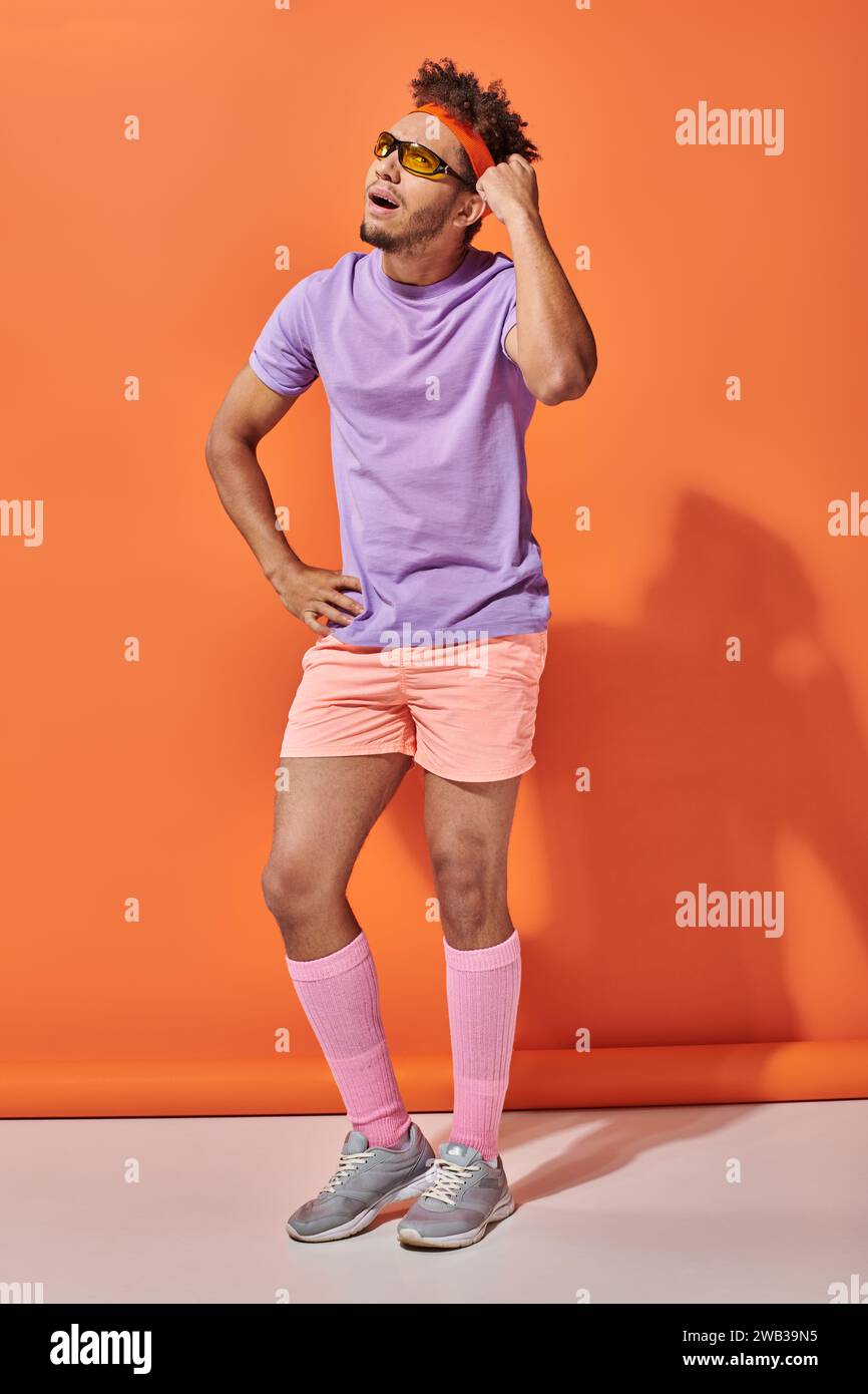 thoughtful african american sportsman in sunglasses and gym attire