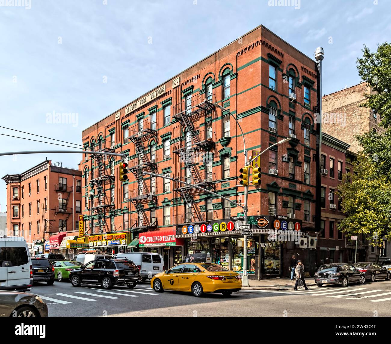EZ Pawn Corp. Building, a five-story apartment house in East Harlem. Corner store adapted subway line designators in its sign. Stock Photo