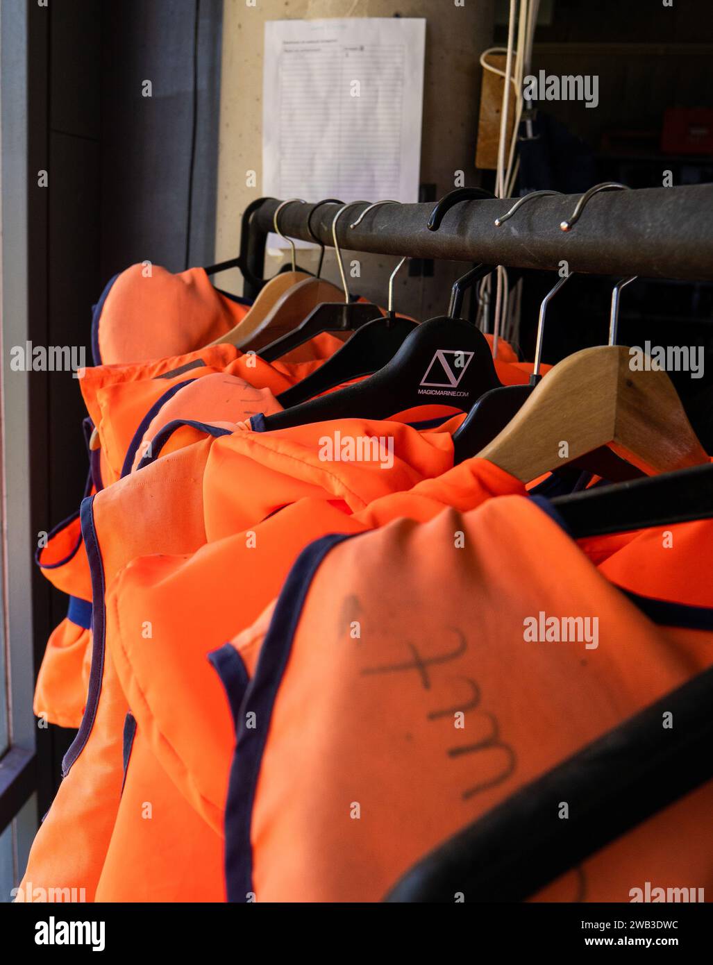 A rack of emergency floating jackets on hangers Stock Photo