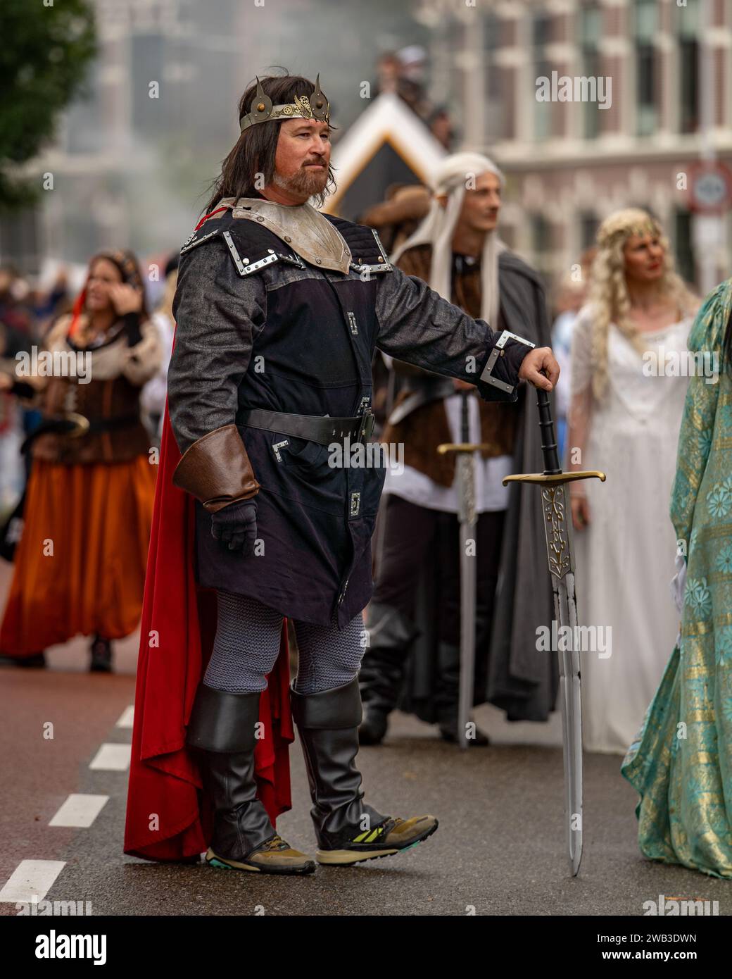 A Caucasian man in a medieval costume marching at a parade in Leiden, Netherlands Stock Photo