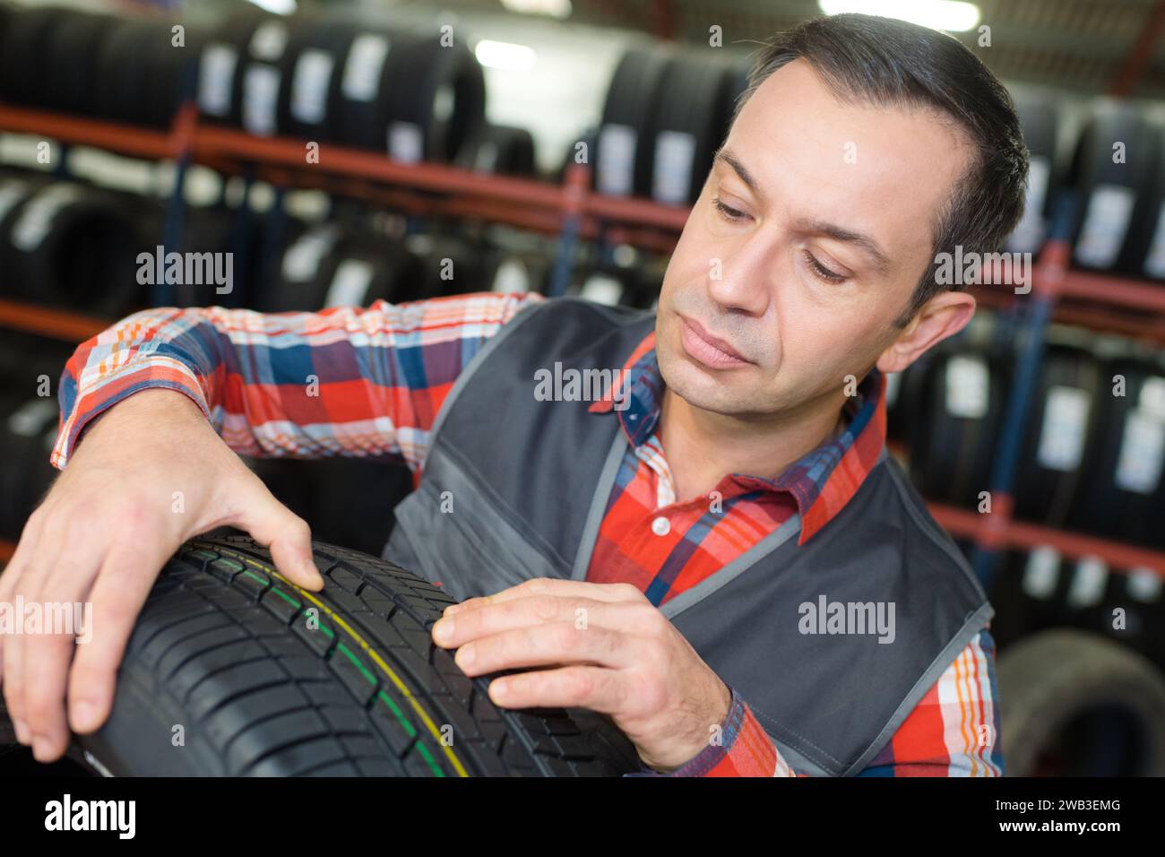 tire specialist inspecting the rubber spike Stock Photo Alamy