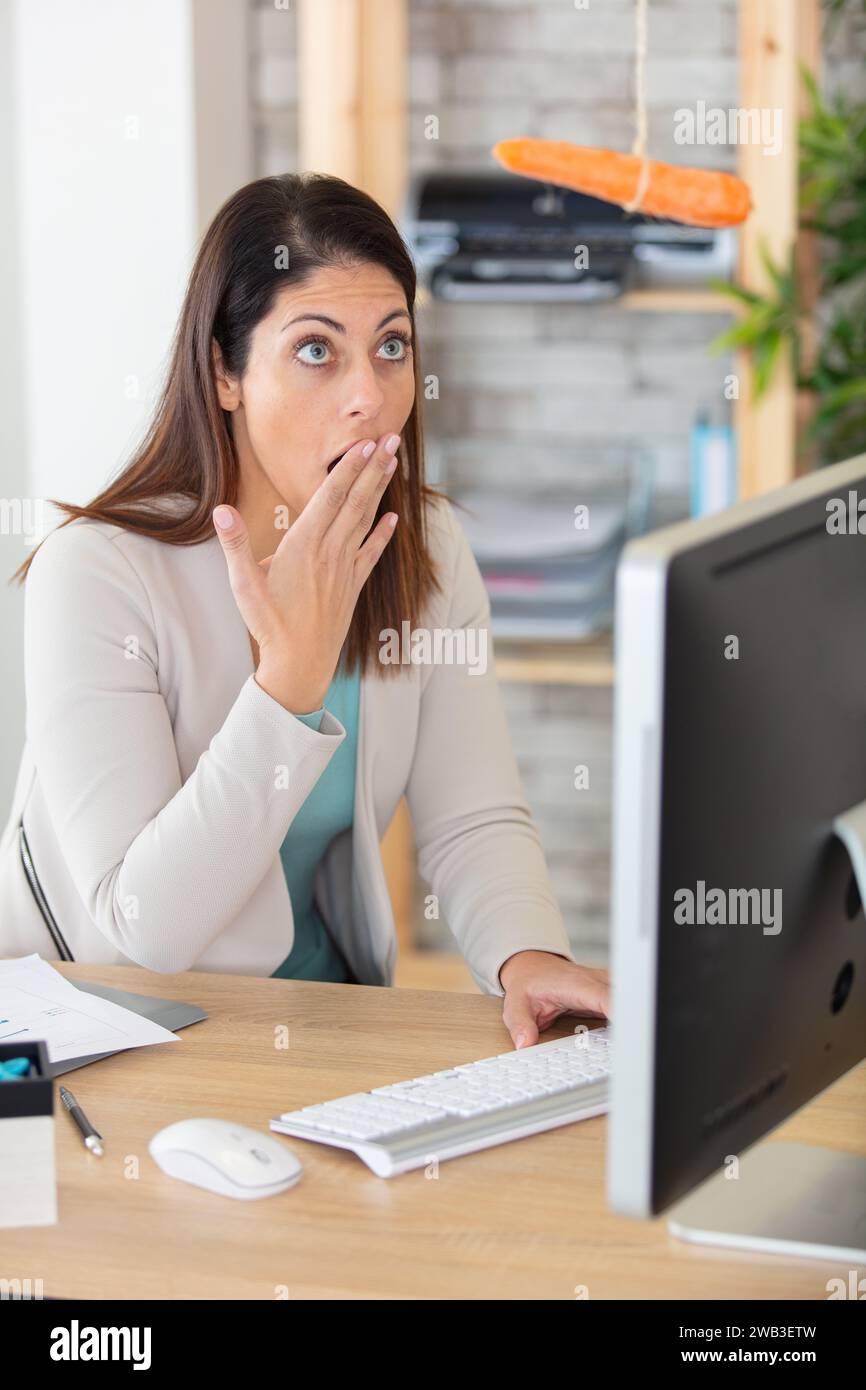 Reading Computer Amazed shocked surprised businesswoman amazed by reading unbelievable online ...