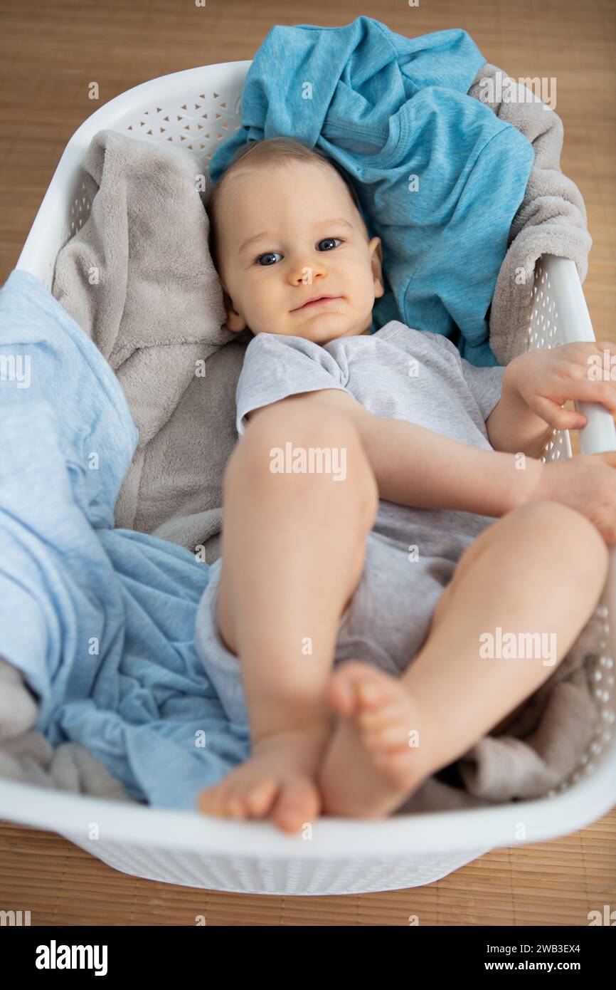 a baby in laundry basket Stock Photo Alamy