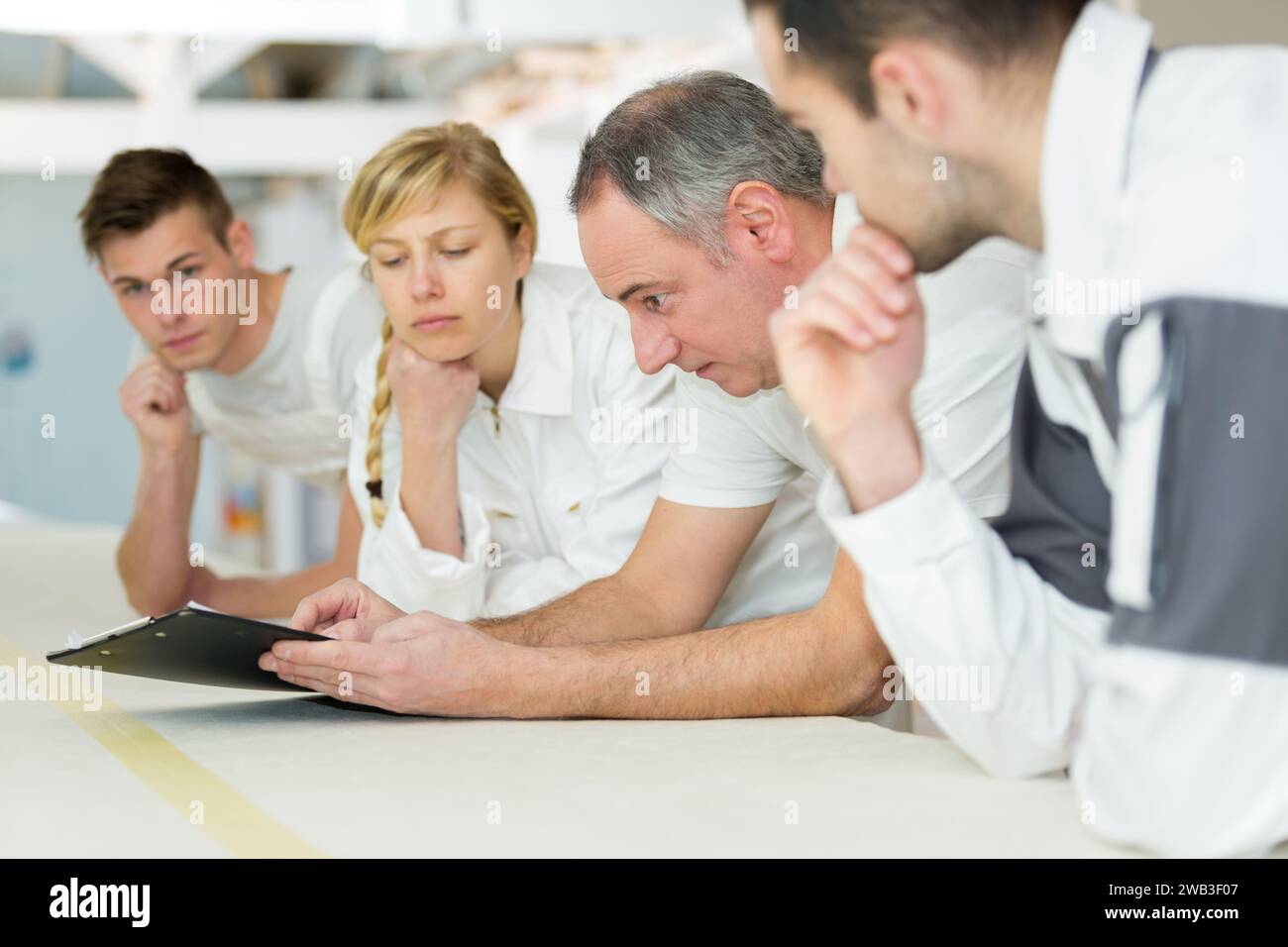 row of pensive students on decorating course Stock Photo