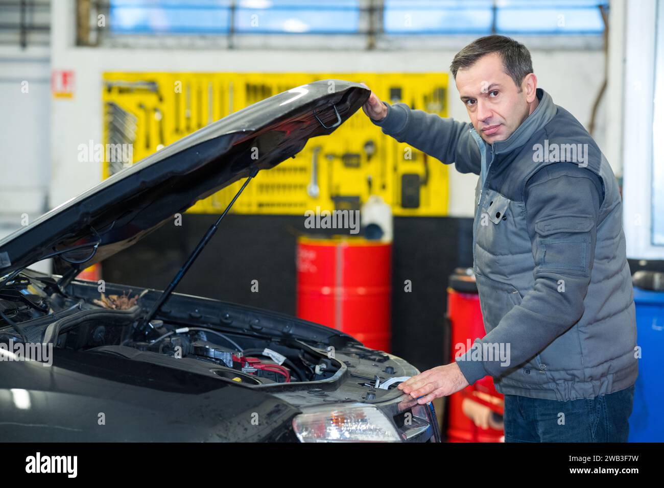 auto mechanic opening car for inspection Stock Photo - Alamy
