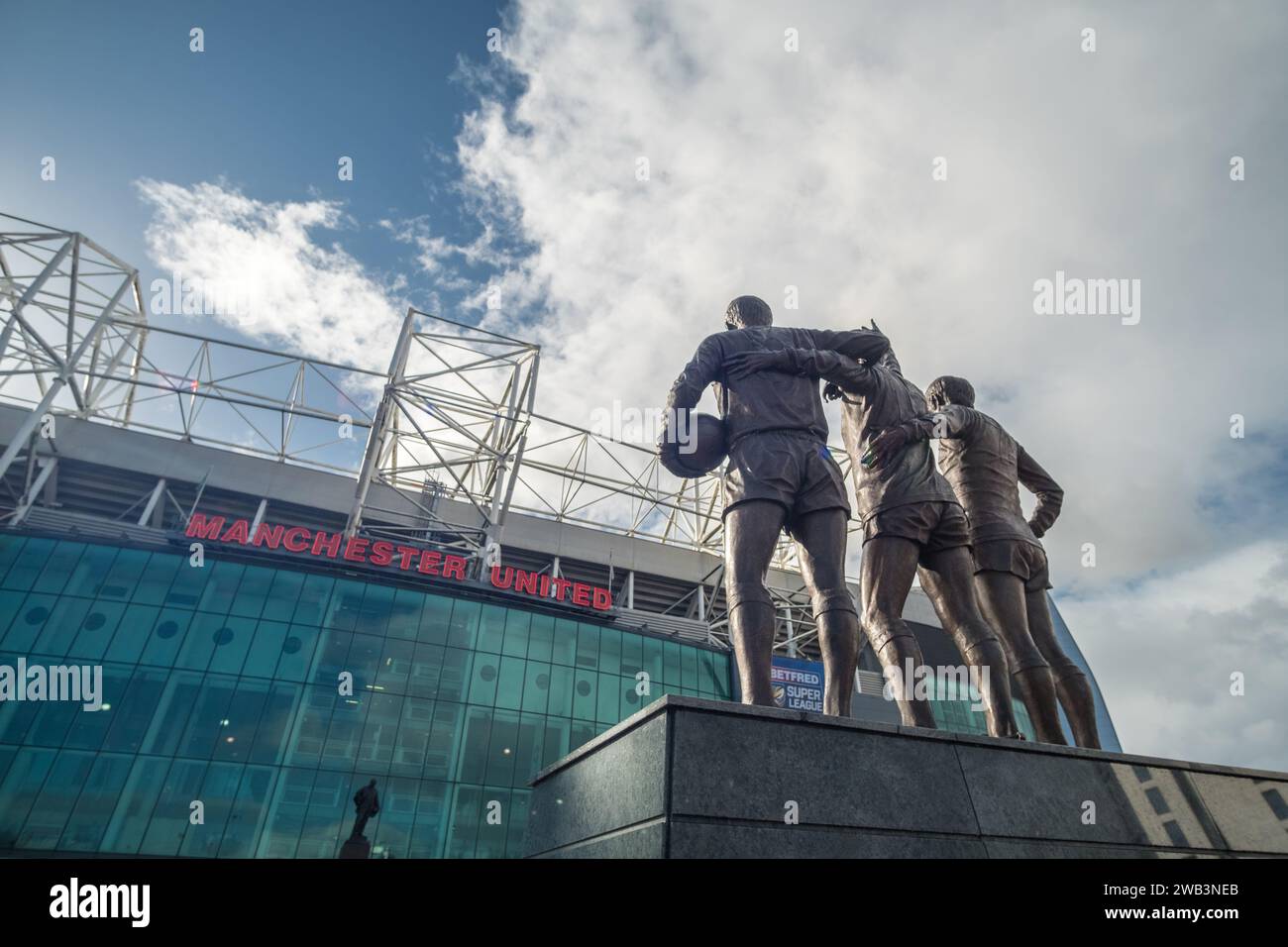 Manchester, England - 5 October 2017 : Old Trafford stadium the home of Manchester United with trio statue of George Best, Denis Law, and Sir Bobby Ch Stock Photo