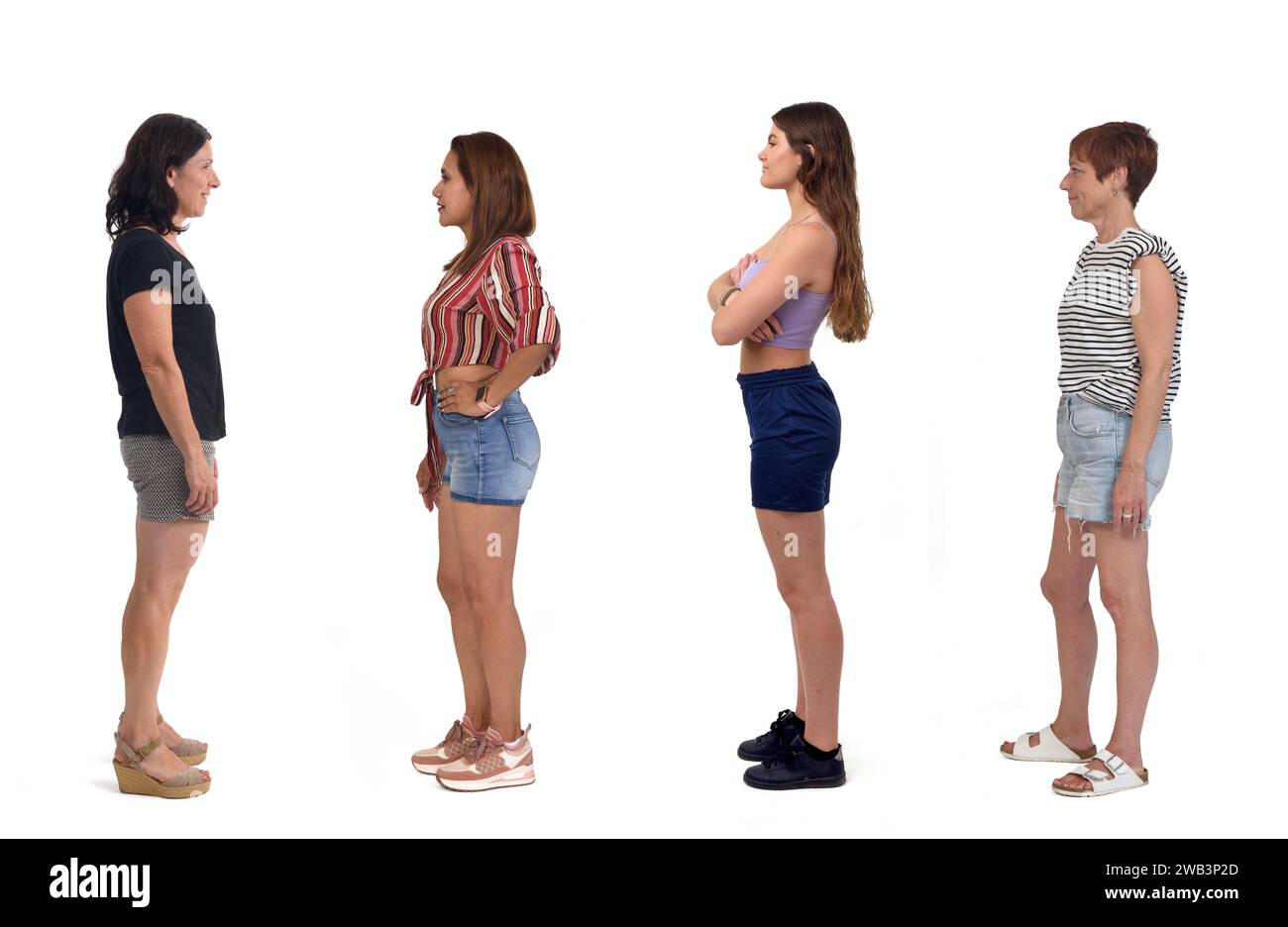 side view of a group of women wearing shorts on white background Stock